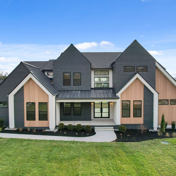 A mockup of a house fully lanscaped with the siding all done by Acre By Modern Mill.