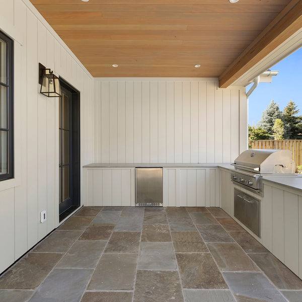 An outside patio with outside appliances all created with Acre By Modern Mill siding.