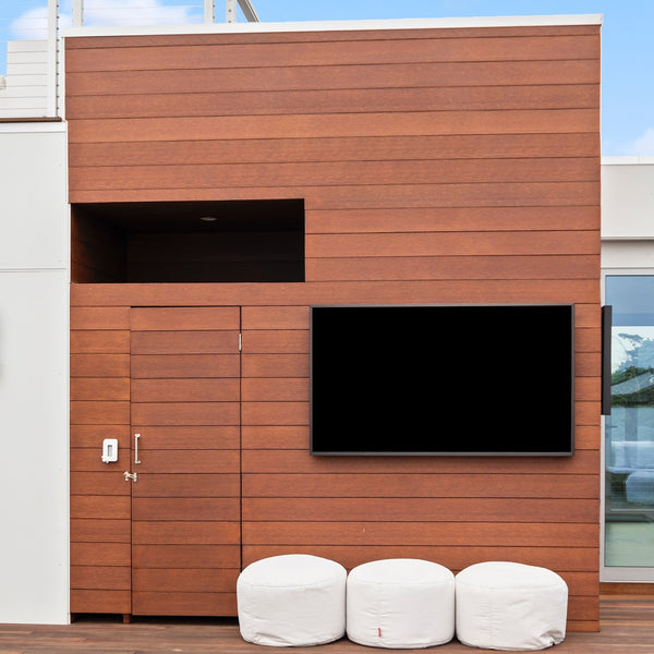 A wall covered with the Acre By Modern Mill siding with a TV hanging on it.