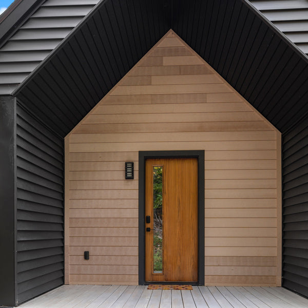 This is a front door covered with Acre By Modern Mill siding.