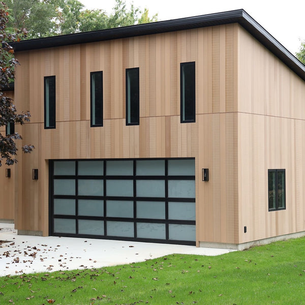 A finished house with the brown Acre by Modern Mill siding. It has a clean minimalistic look to it with grass surrounding the house.