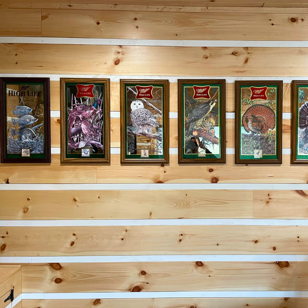Adze Appalachian Siding with Miller High Life photos hanging on the wall.