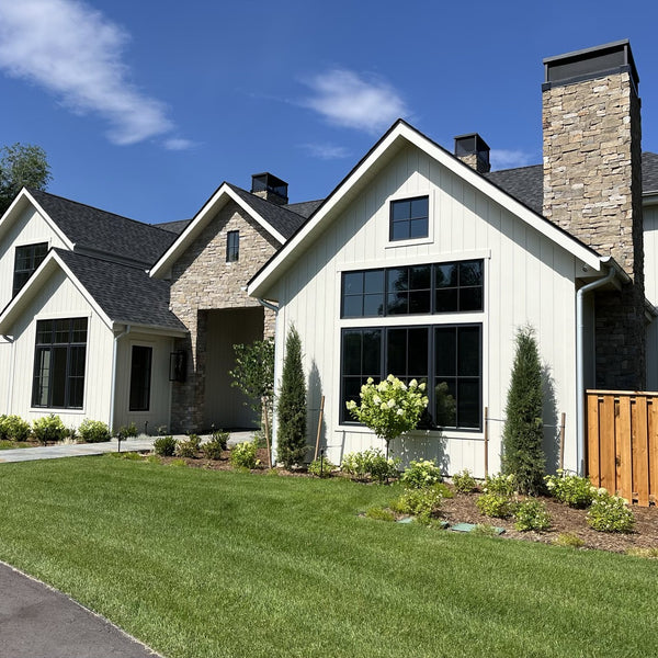 White Acre by Modern Mill siding on a finished house with clean landscaping in front of it. 