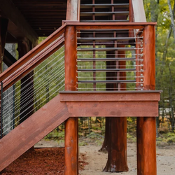 An outside staircase outside that has a cable rail system.