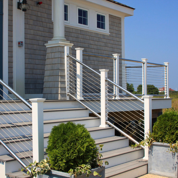 A white cable railing system with stainless steel poles as the main railing. Attached as the entryway. 