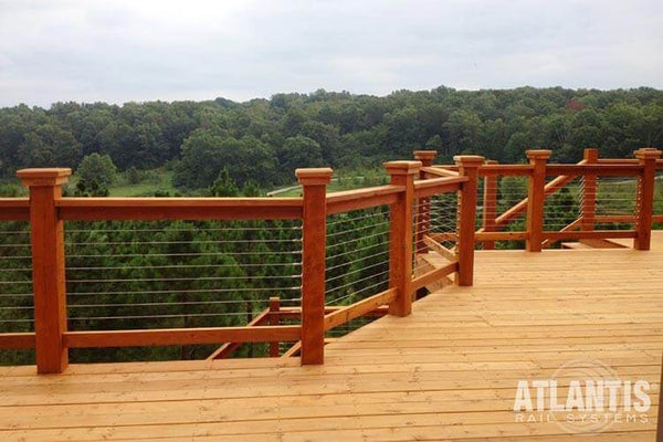 A deck with cable rail system overlooking the woods. 