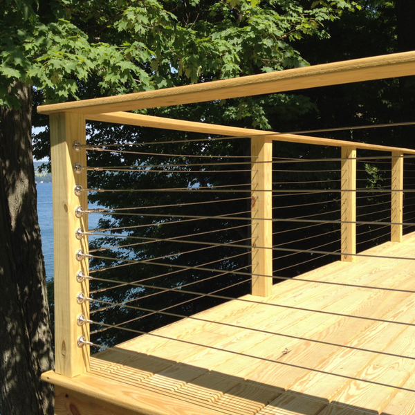 A deck on a lake front house with cable rail system. 