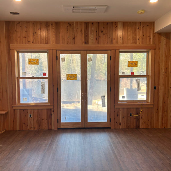 living room with double doors and western red cedar wall