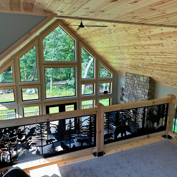 Railing overlooking the living room with a wall of windows. The raining is made of decorative railing panels. 