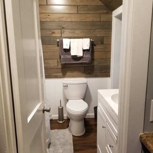 A bathroom with the driftwood paneling 