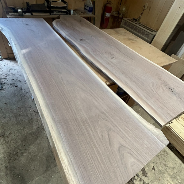 Two darker hardwood slabs on a preparation table. 