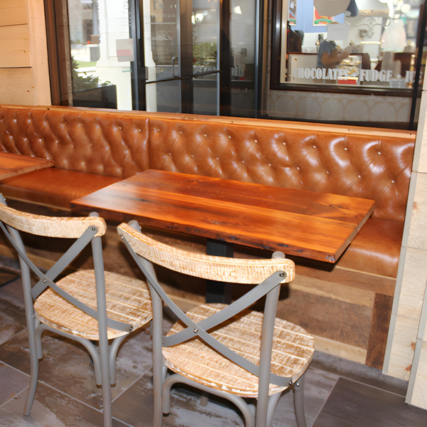 Booth area in a restaurant using hardwood slabs as withe tables. Completed with minimalistic chairs. 