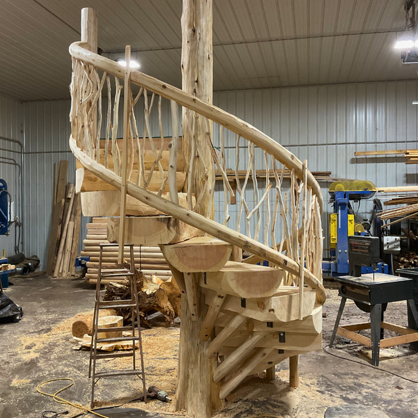 Spiral log staircase being built in a workshop