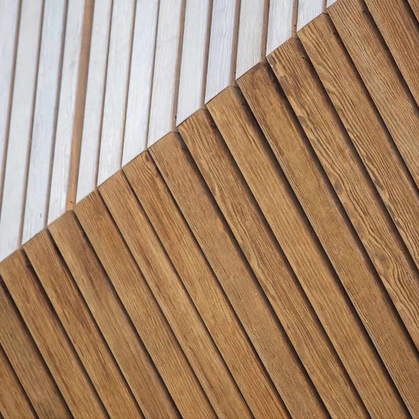 Two different colors of Kebony siding next to each other. They are on display to compliment each other.