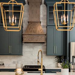 Green minimalistic cabinets with gold light fixtures and modern style appliances. 