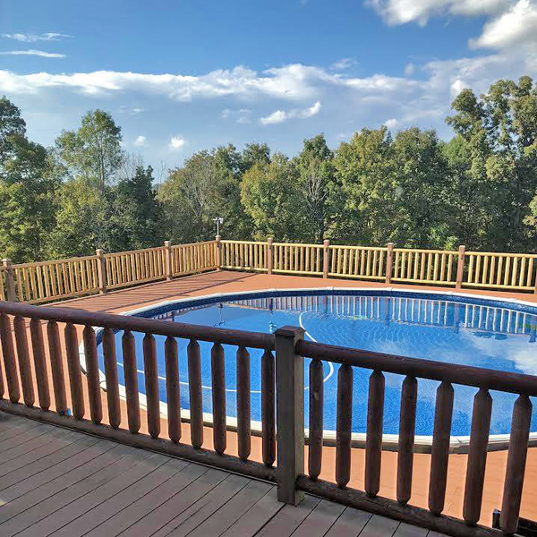 In ground pool with rapid log railing around it.