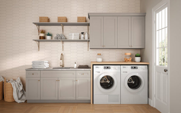 Grey Mantra cabinets in a laundry room with white back splash and grey shelves.