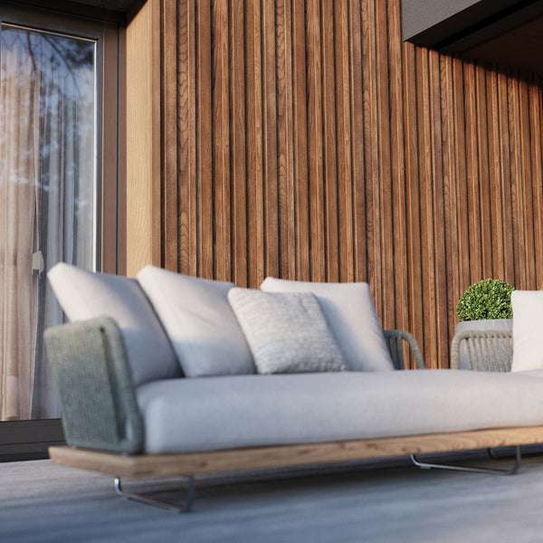 Millboard Envello siding behind a couch on the porch. This accent wall brings out brightness on the porch. 