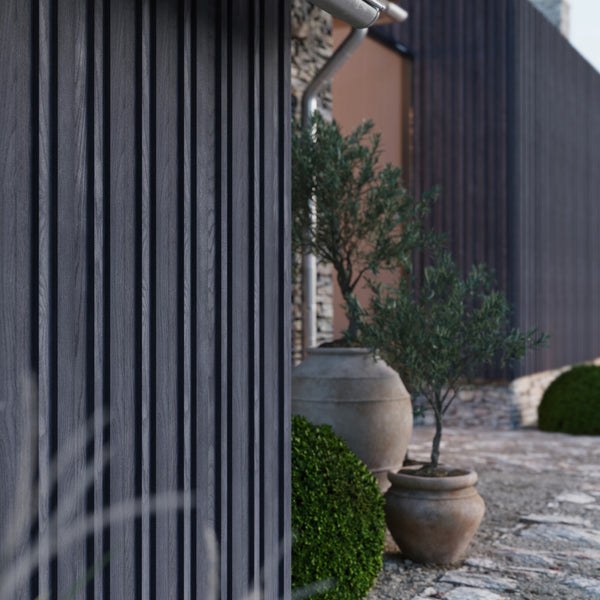 Millboard Envello Siding black placed along the siding of this house. plants are in front of it to create a welcoming feel. 