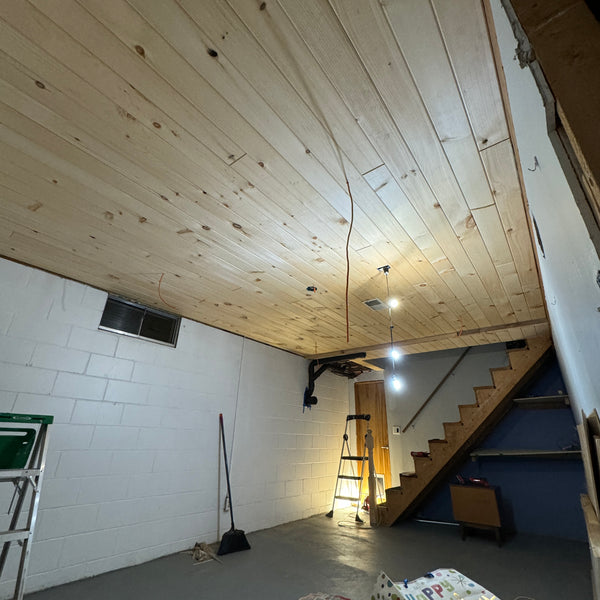 Rustic Grade Tongue and Groove Pine - Unfinished on the ceiling of a basement. 