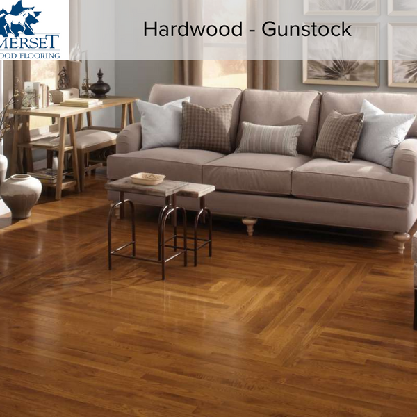 Living room with grey couches completed with gunstock color Somerset hardwood flooring. 