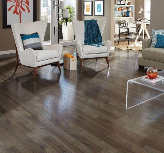 Ling space with two white chairs and someset hardwood flooring. 