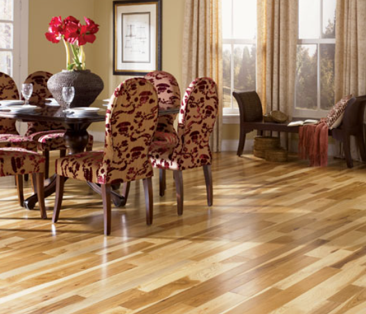 Dining room table in the dining room with a bench looking out the window. Completed with Somerset Hardwood Flooring. 