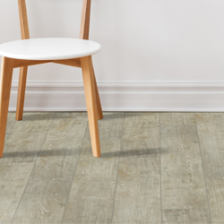 A chair sitting on southwind vinyl natural blonde. 