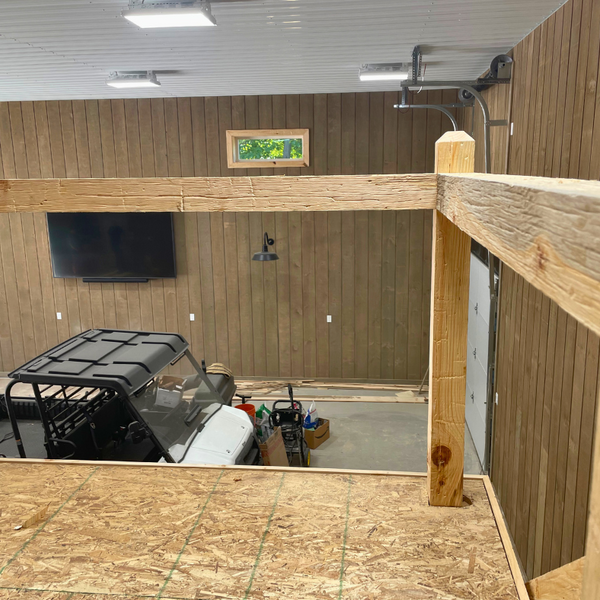 Railing overlooking shop made out of old wood surfacing