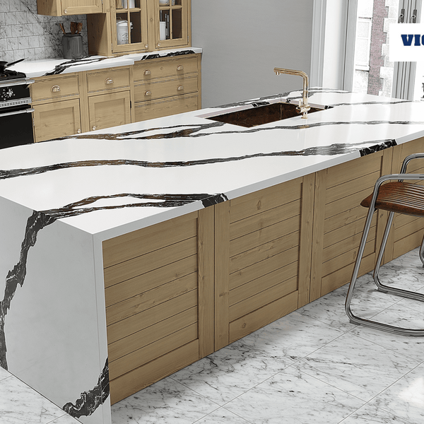A kitchen with Vicostone Quartz countertops and brown cabinets. Black appliances and brown stools underthe island. 