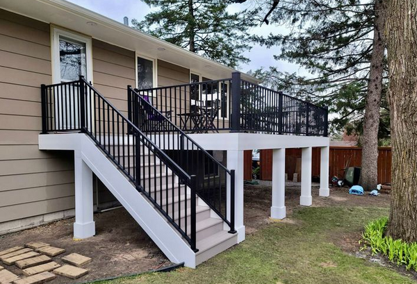 White raised deck connected to the house completed with Westbury Aluminum railing. 