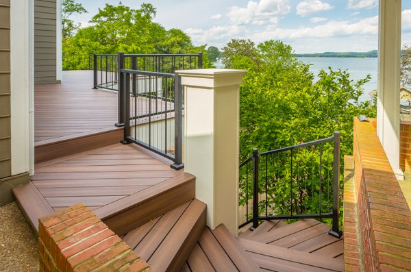 Beach house with a deck with a staircase the leads to the lower level completed with a Westbury Aluminum railing.
