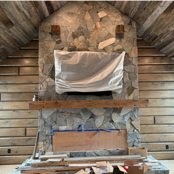 Chimney with white pine paneling behind it for a accent wall.
