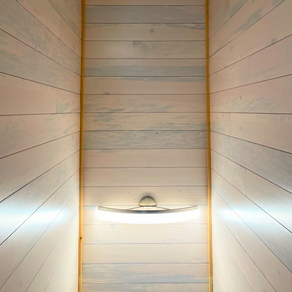 A picture taken looking at a ceiling with the walls that have white pine nickel gap paneling 