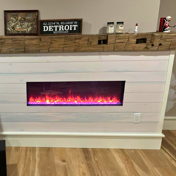 A fire place completed with a old wood surfacing mantel and white pine nickel gap paneling. 