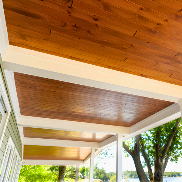 A ceiling finished with White Pine T&G Paneling Pre-finished - Copper - Homestead Timbers and white beams.