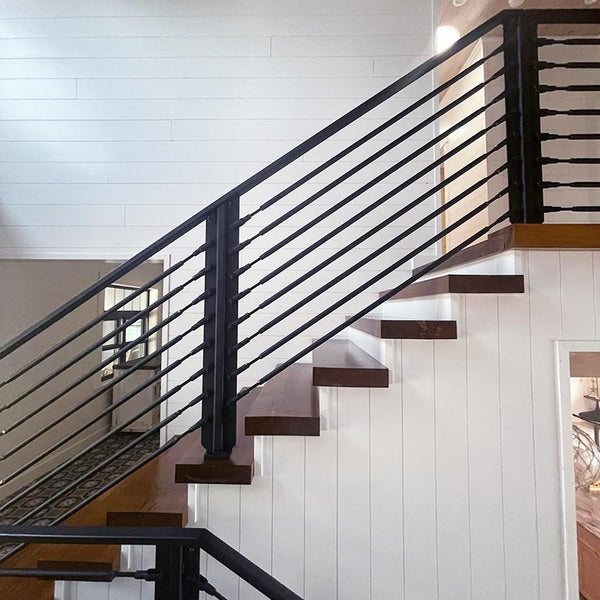 Staircase with White Pine Tongue & Groove Pre-finished. Black railings and brown steps.