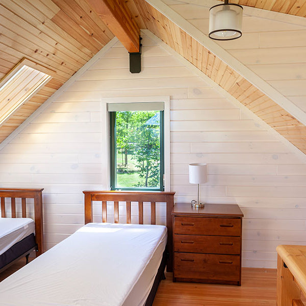 A beautiful pairing of whitewash and empire clear coat finishes to tie the attic bedroom together. White Pine T&G Paneling Pre-finished - Whitewash - Homestead Timbers