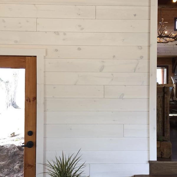 Wall with white pine tongue and groove on it. 