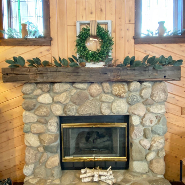 Reclaimed Barn Beam mantel with stone fireplace