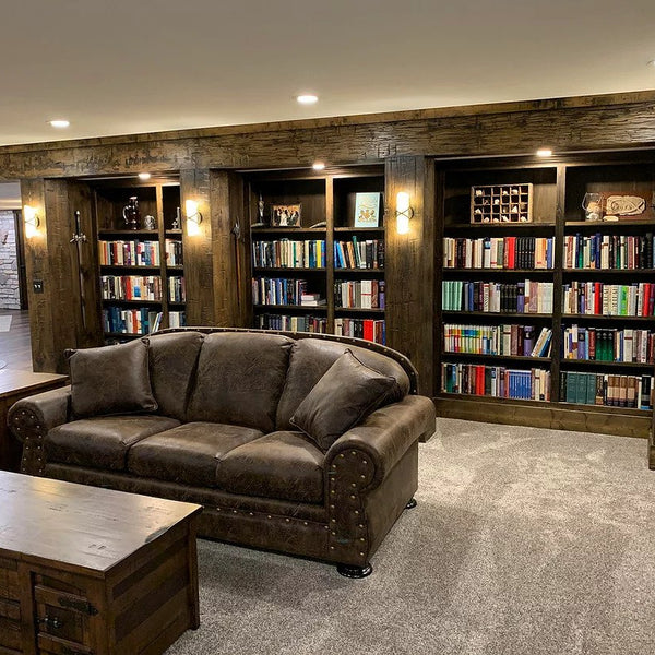  A living room with a bookcase made out of old wood surfacing. 