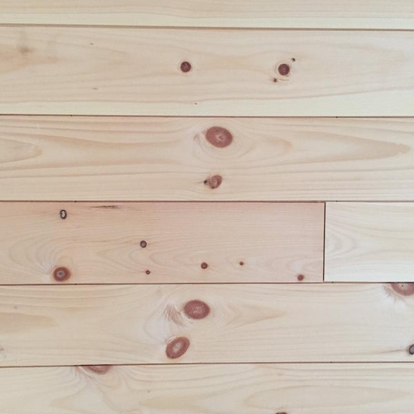 White pine 1x6 nickel gap end matched unfinished installed on wall.