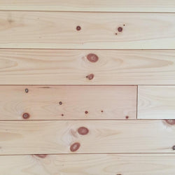 White pine 1x6 nickel gap end matched unfinished installed on wall.